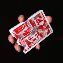 Load image into Gallery viewer, Hand holding two red and white playing cards against a black background