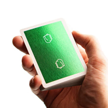 Load image into Gallery viewer, Hand holding a deck of green playing cards with white icons on a white background