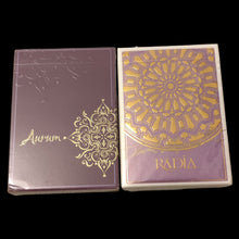 Load image into Gallery viewer, Two purple card decks with gold designs on a beige surface
